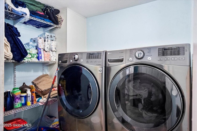 clothes washing area featuring washing machine and clothes dryer