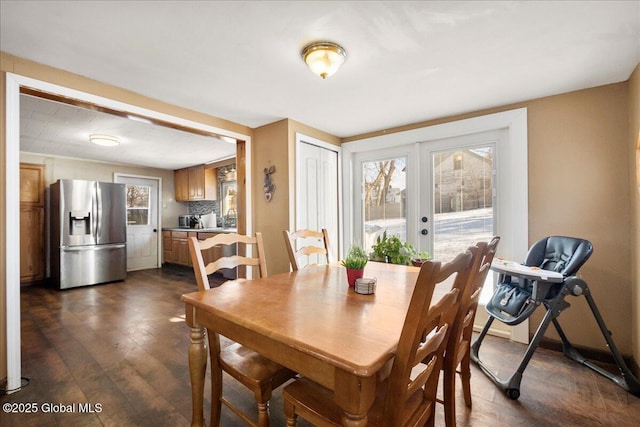 dining room with plenty of natural light, dark hardwood / wood-style floors, sink, and french doors