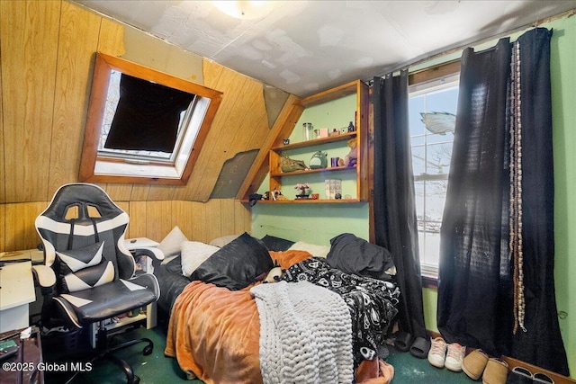 carpeted bedroom featuring a skylight and wooden walls