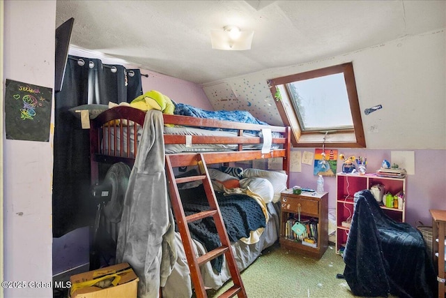 bedroom with vaulted ceiling with skylight and carpet floors