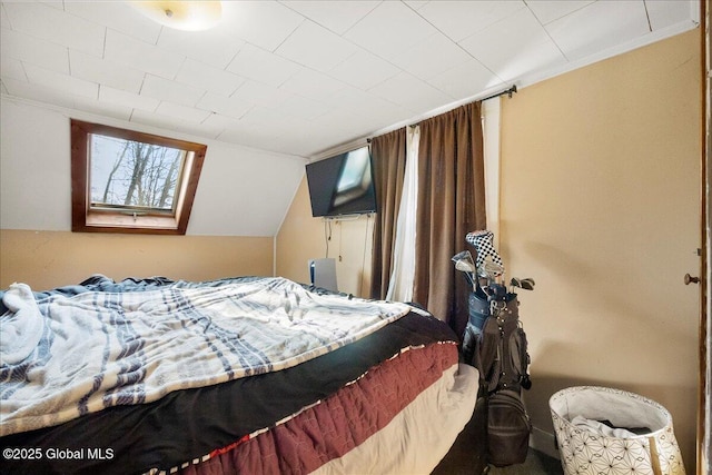 bedroom with lofted ceiling with skylight and ornamental molding