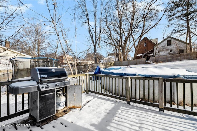 snow covered deck featuring area for grilling