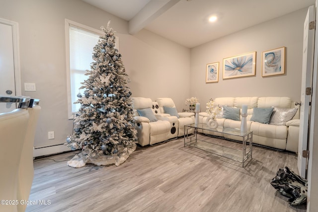 living room with a baseboard heating unit, beam ceiling, and light hardwood / wood-style floors