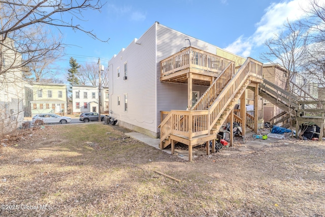 rear view of property featuring a wooden deck