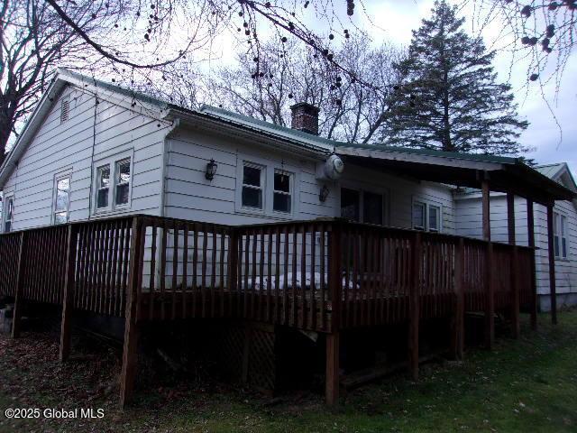 back of property featuring a wooden deck