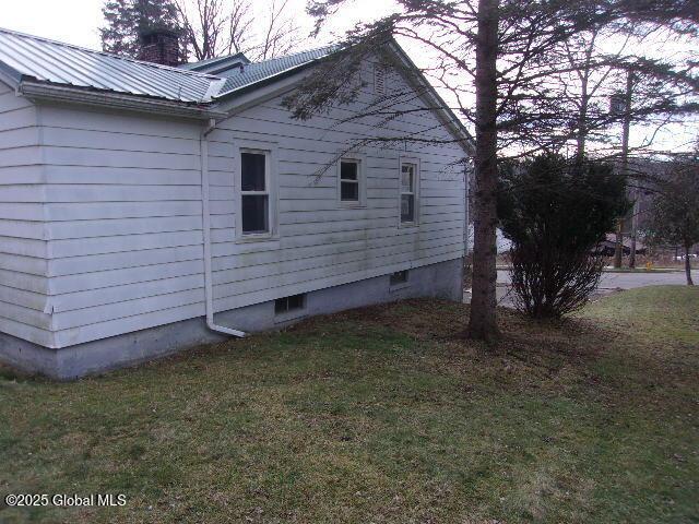 view of side of home featuring a yard