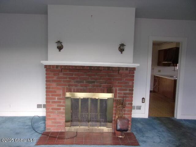 room details with a brick fireplace and carpet floors