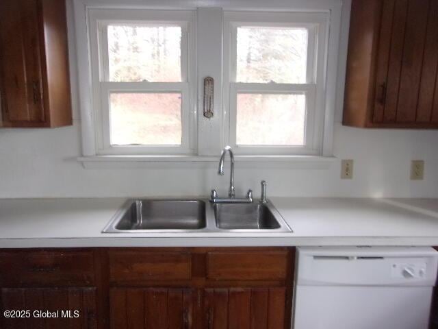 kitchen featuring white dishwasher and sink