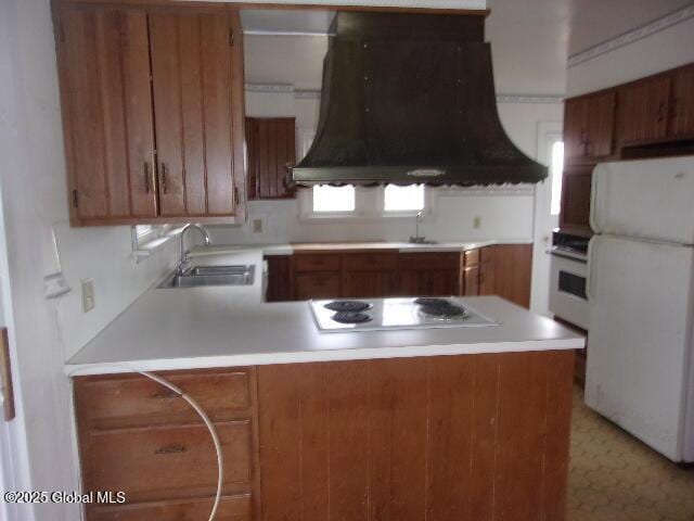 kitchen featuring white appliances, kitchen peninsula, custom exhaust hood, and sink