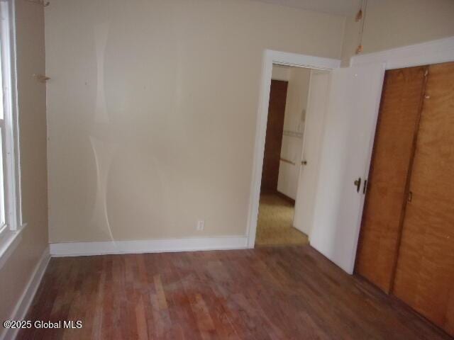 unfurnished room featuring dark hardwood / wood-style floors