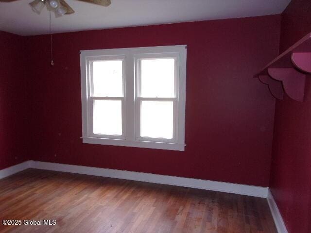 interior space featuring wood-type flooring and ceiling fan