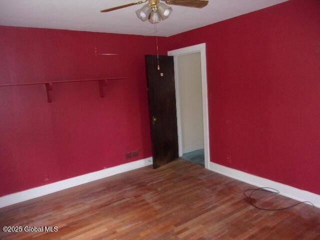 unfurnished room featuring ceiling fan and hardwood / wood-style floors