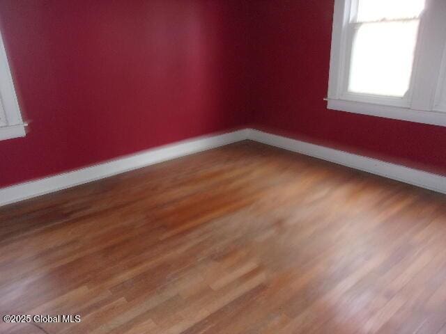 empty room with hardwood / wood-style flooring