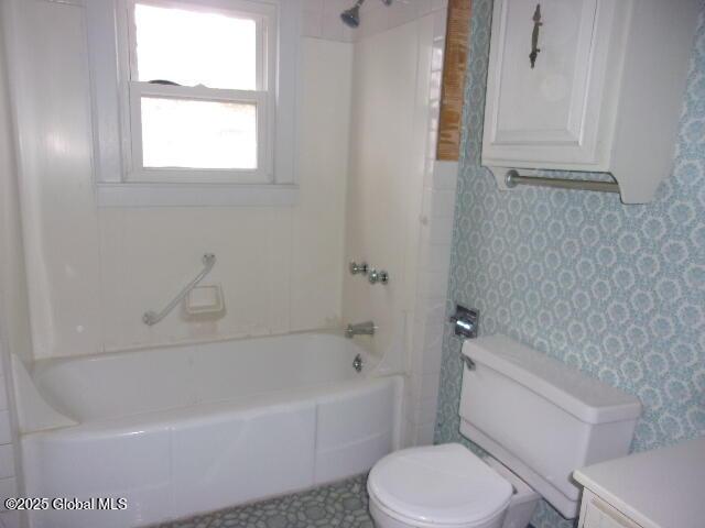 full bathroom featuring toilet, vanity, and tub / shower combination