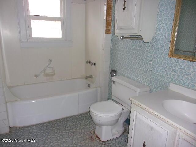 full bathroom featuring toilet, tub / shower combination, and vanity