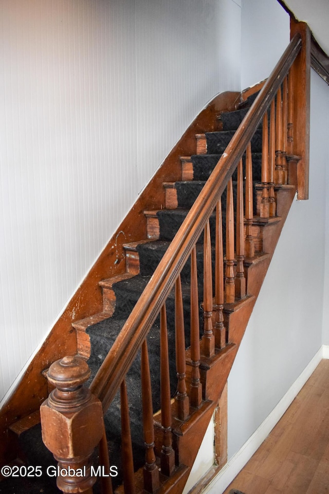 stairs featuring hardwood / wood-style flooring