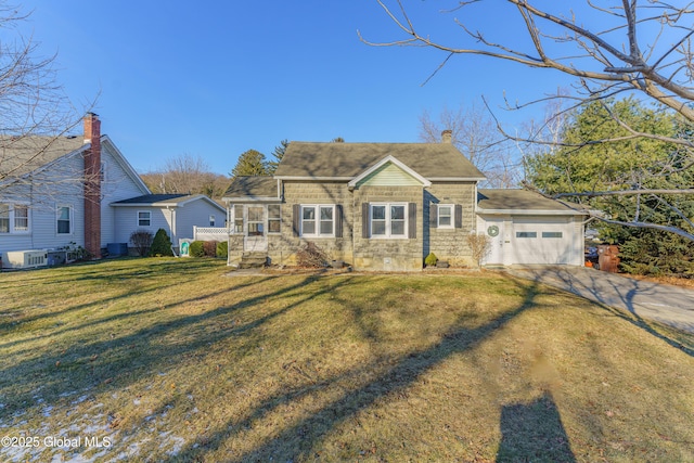 view of front of home with central AC, a garage, and a front yard