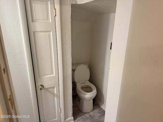 bathroom featuring tile patterned floors and toilet