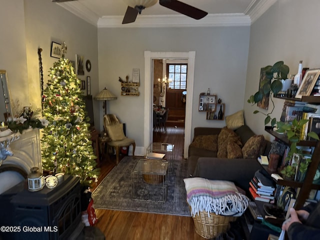 living room with ceiling fan with notable chandelier, crown molding, and hardwood / wood-style floors