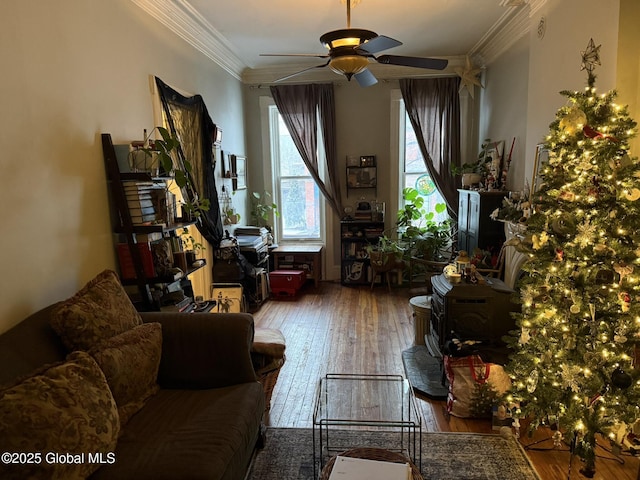 sitting room featuring ceiling fan, ornamental molding, and wood-type flooring