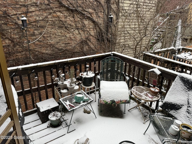 view of snow covered back of property