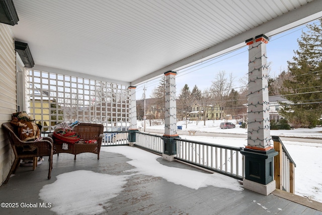 snow covered patio featuring a porch