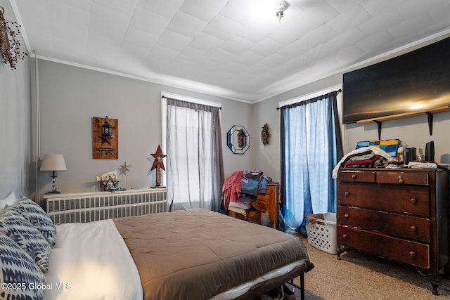 bedroom featuring radiator heating unit, multiple windows, ornamental molding, and light carpet