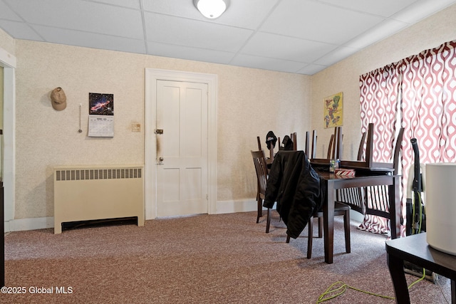 interior space featuring radiator heating unit and a paneled ceiling