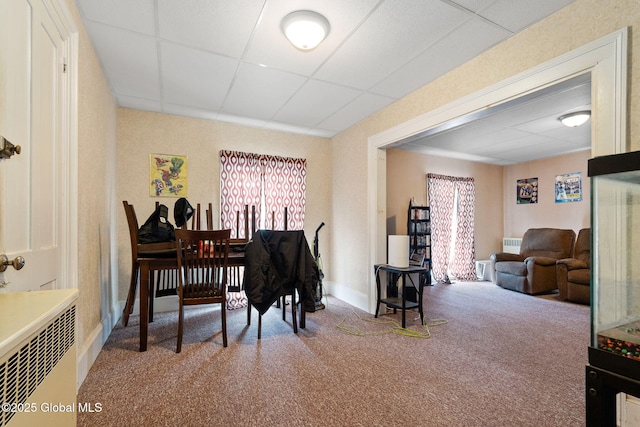 miscellaneous room featuring a paneled ceiling and carpet flooring