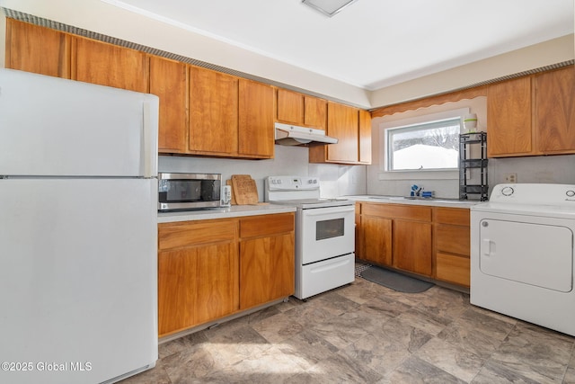 kitchen with white appliances and washer / clothes dryer