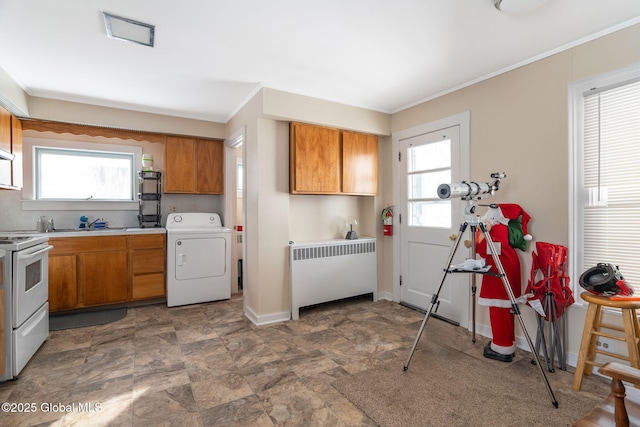 kitchen featuring ornamental molding, electric range, radiator, and washer / clothes dryer