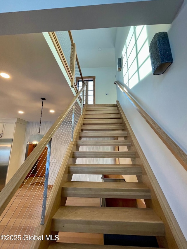 staircase featuring recessed lighting