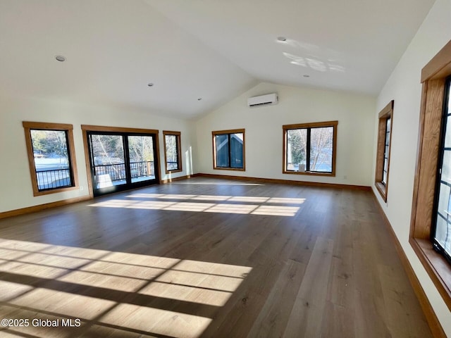 spare room with high vaulted ceiling, dark wood-style floors, baseboards, and an AC wall unit