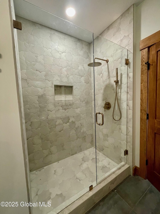 full bath with tile patterned flooring and a shower stall