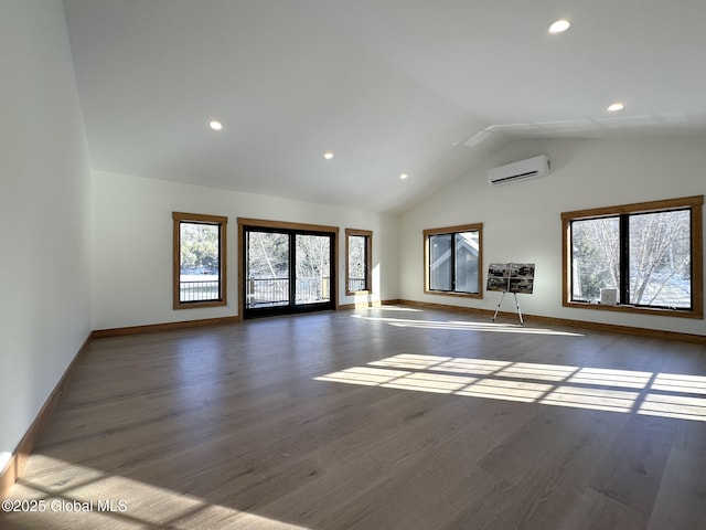 unfurnished living room with baseboards, high vaulted ceiling, dark wood-style flooring, and a wall mounted AC