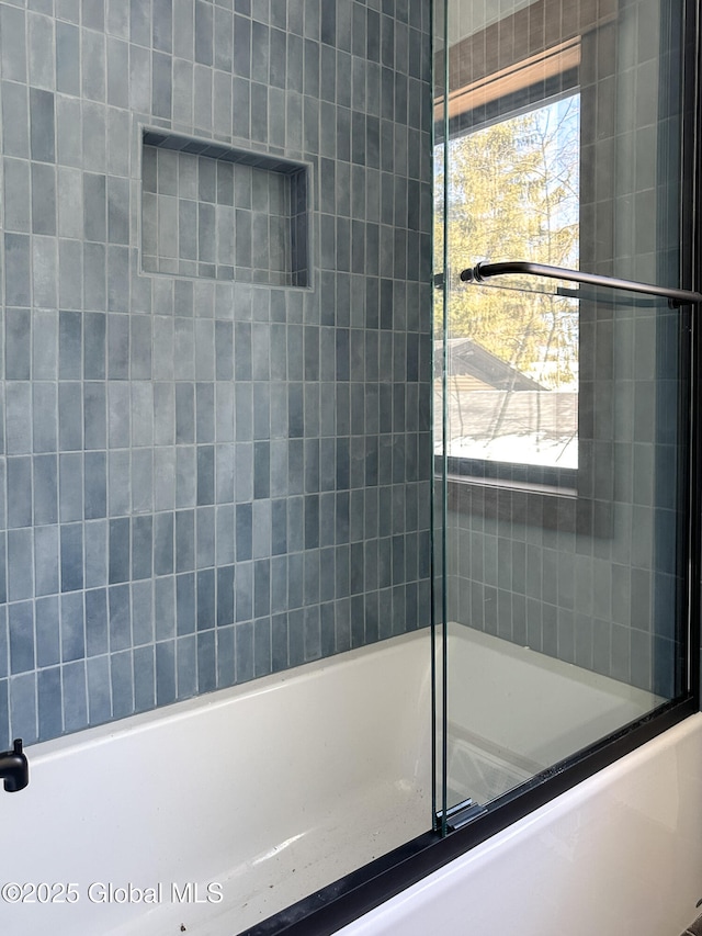 bathroom with enclosed tub / shower combo and a wealth of natural light