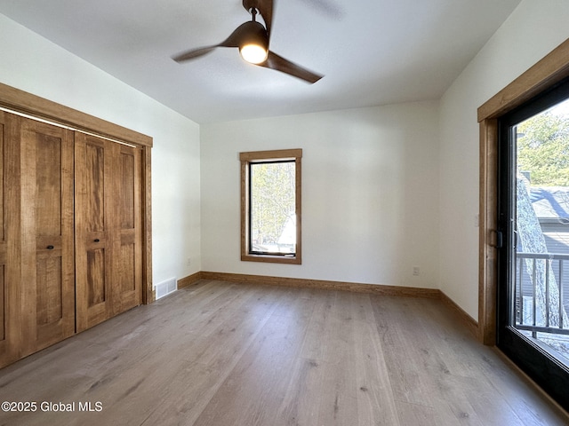 unfurnished bedroom with visible vents, baseboards, light wood-style flooring, ceiling fan, and access to outside