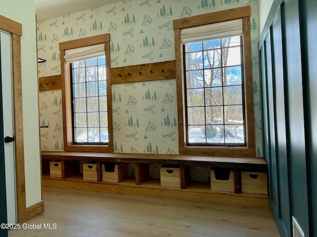 mudroom with light wood-type flooring and wallpapered walls