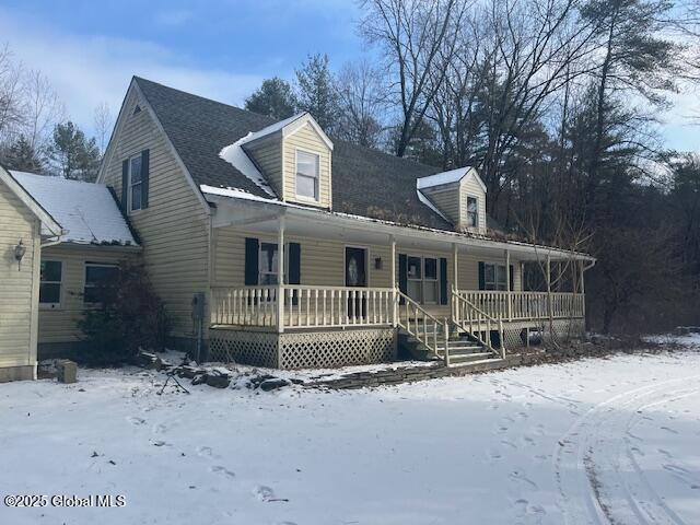 cape cod-style house with covered porch