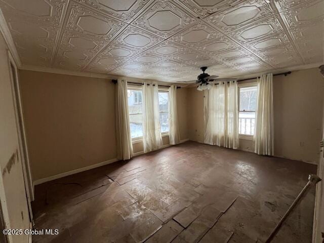 unfurnished room featuring ceiling fan and plenty of natural light