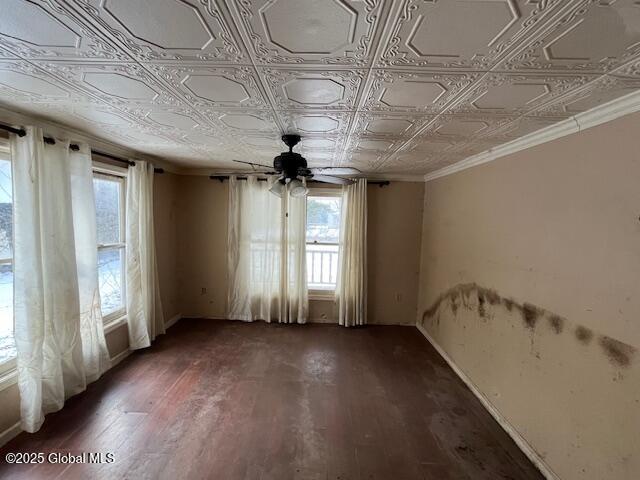 empty room featuring ceiling fan and dark wood-type flooring