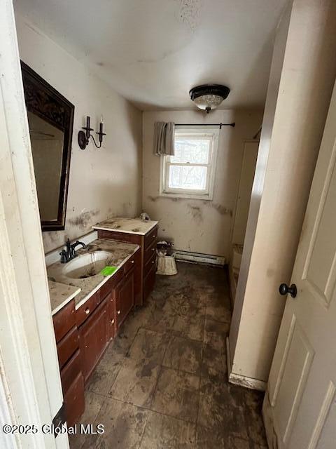 bathroom with a baseboard heating unit and vanity