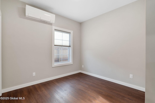 unfurnished room with dark hardwood / wood-style flooring and an AC wall unit