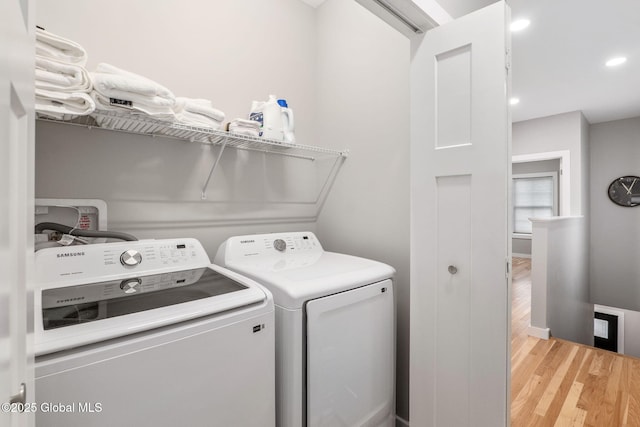 washroom with washer and dryer and wood-type flooring