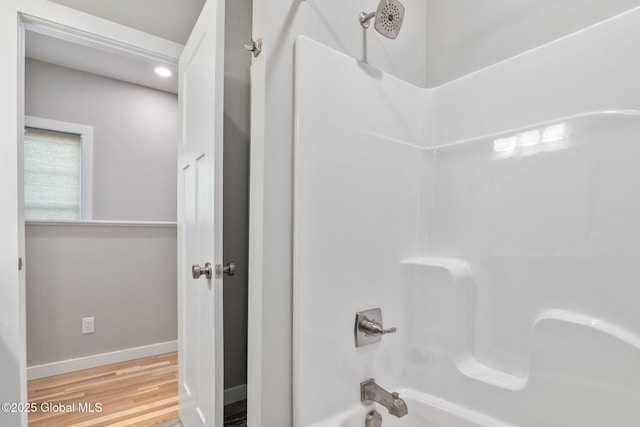 bathroom featuring shower / bathtub combination and hardwood / wood-style flooring