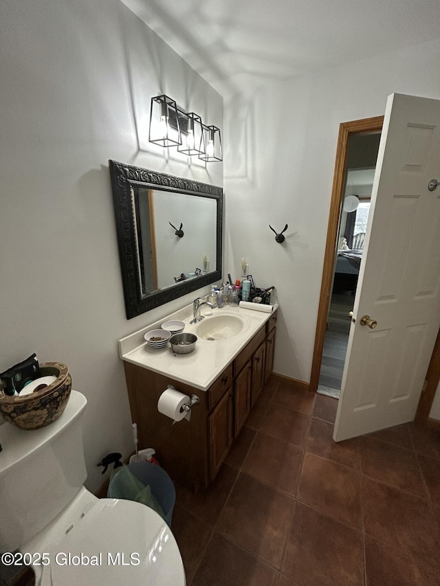 bathroom with vanity, tile patterned floors, and toilet