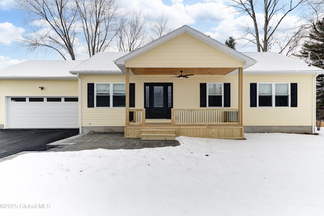 view of front facade with a garage, ceiling fan, and covered porch