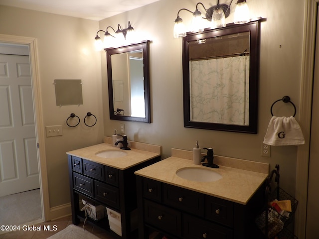 bathroom with tile patterned flooring, walk in shower, and vanity