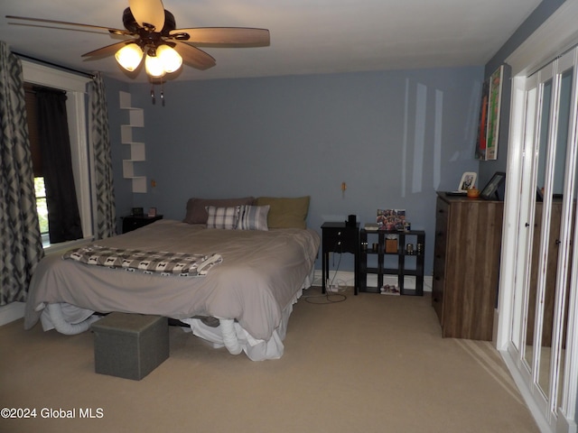 bedroom featuring ceiling fan and light colored carpet