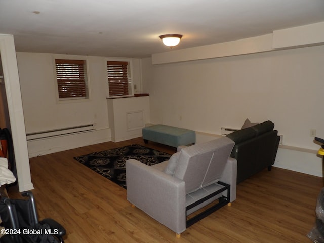 living room featuring a baseboard heating unit and hardwood / wood-style floors